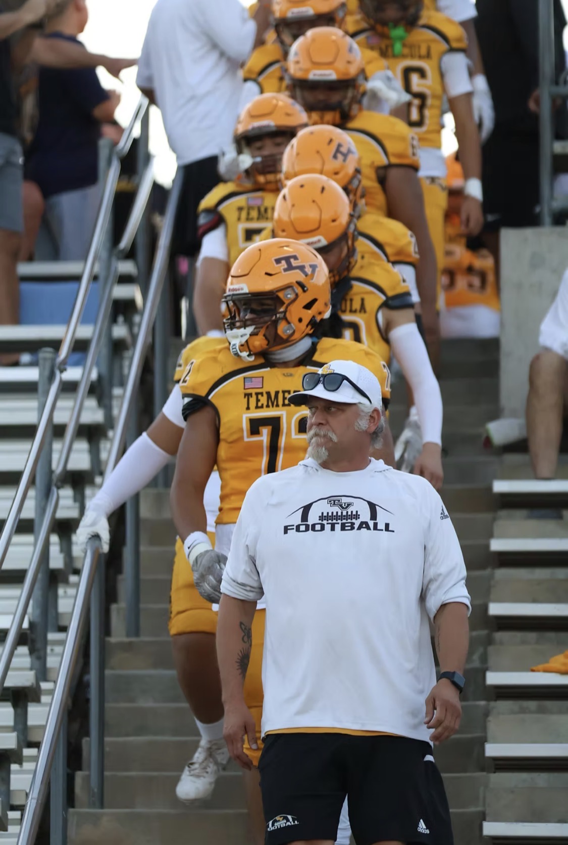 Joel Nichols leading Temecula Valley players down stadium steps